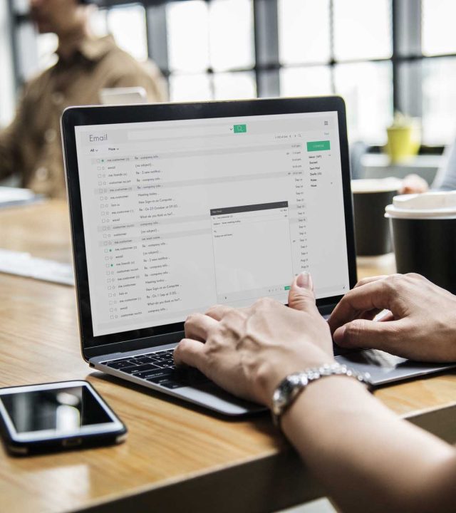 Woman checking her email in a meeting Woman checking her email in a meeting